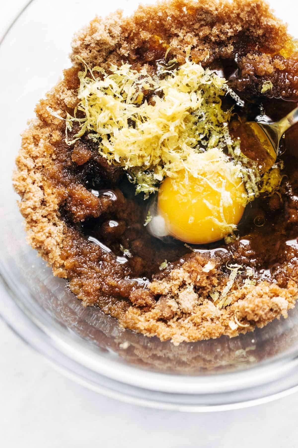 Ingredients in bowl for lemon poppyseed zucchini muffins.