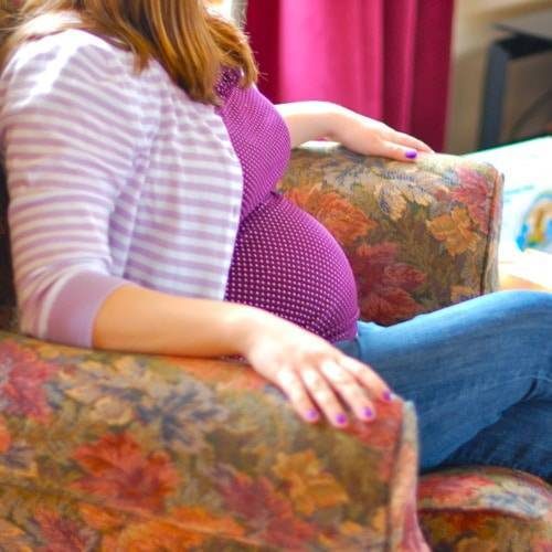 Pregnant woman sitting in a chair.