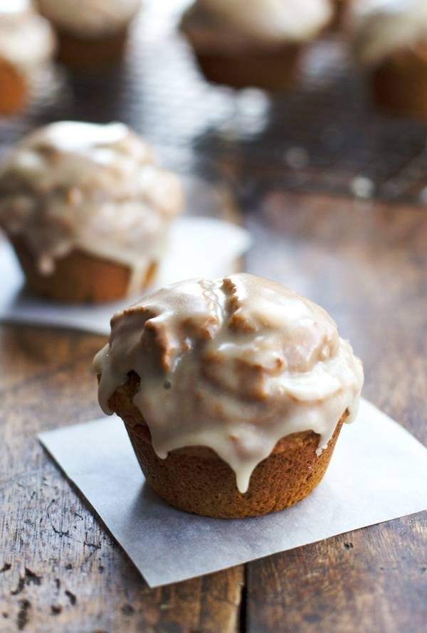 Healthy Maple Glazed Pumpkin Muffins on parchment paper.