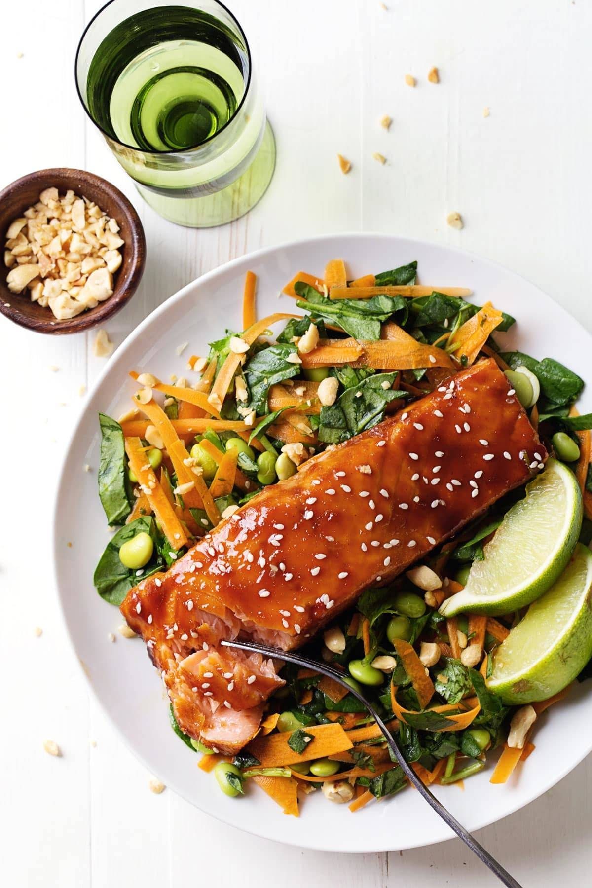 Simple Hoisin Glazed Salmon on a salad with limes.