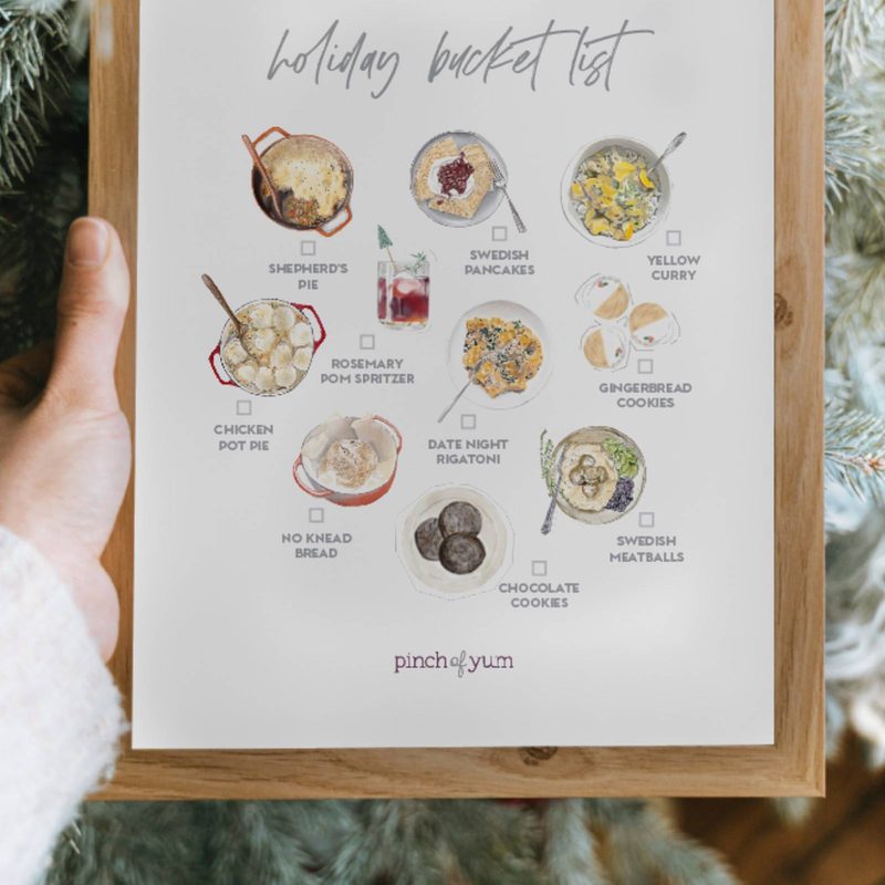 Holiday bucket list in a frame in front of a holiday tree.