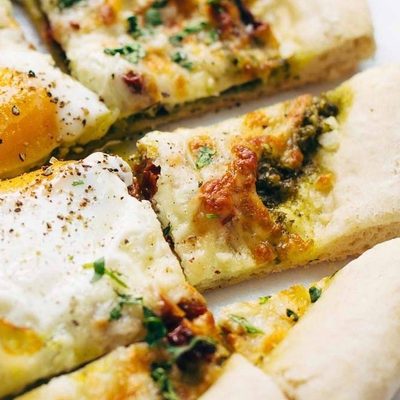 Breakfast Pizza sliced with eggs.