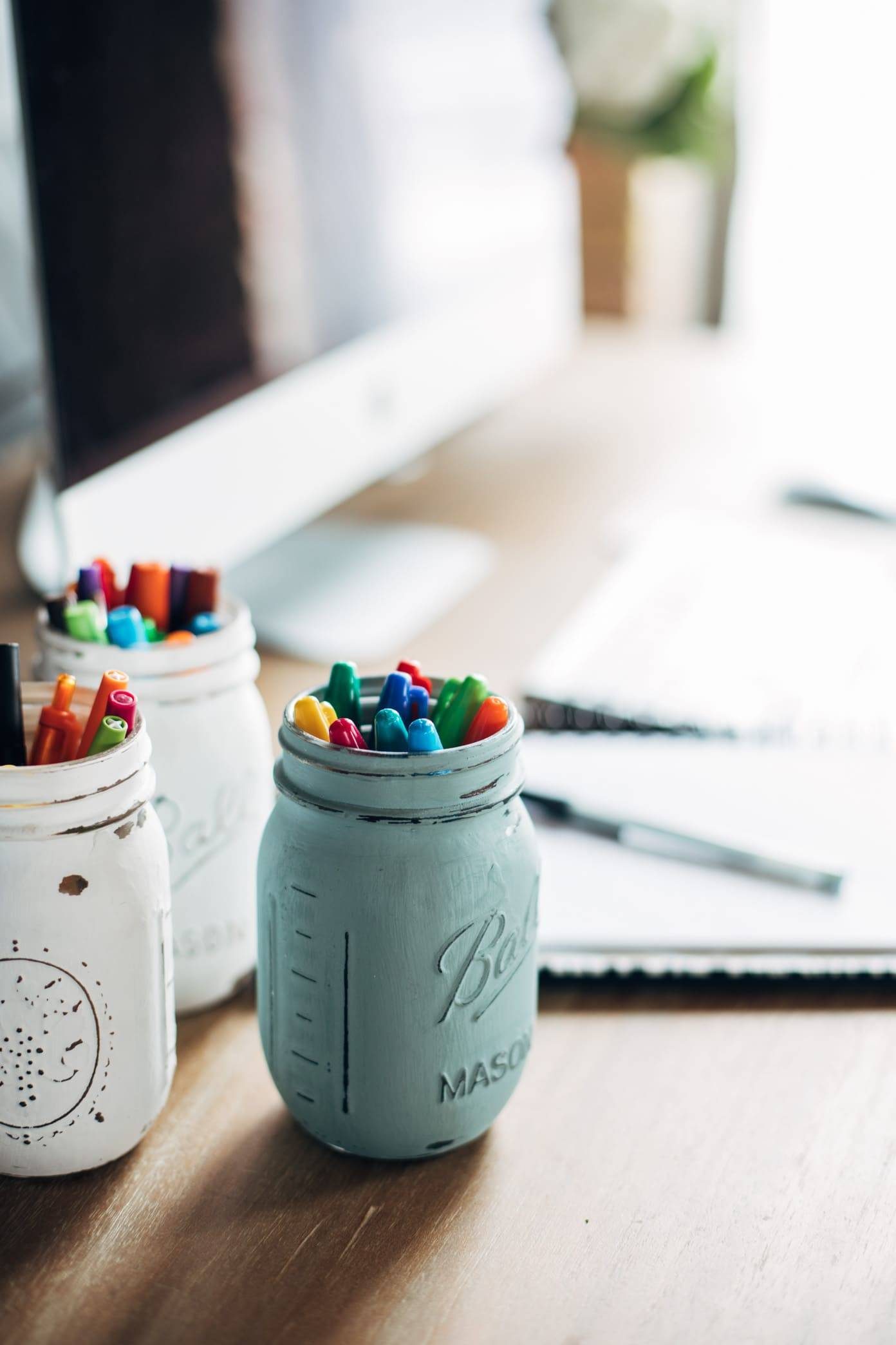 Painted jar with markers.