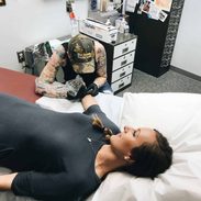 Lindsay getting a tattoo.