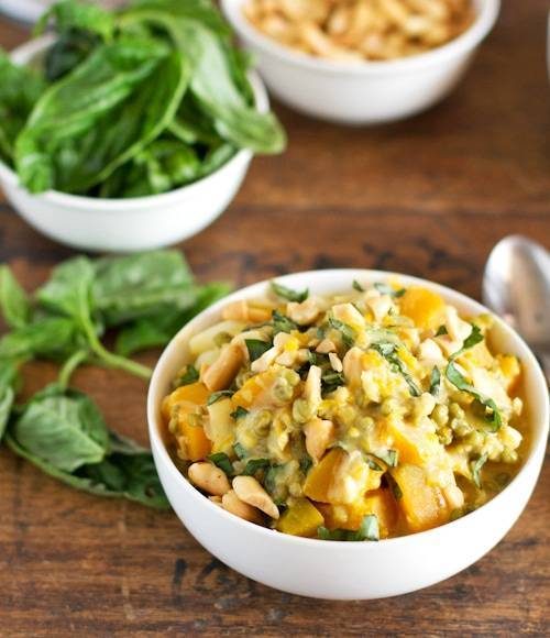 Thai basil coconut lentils in bowls with basil on the side.