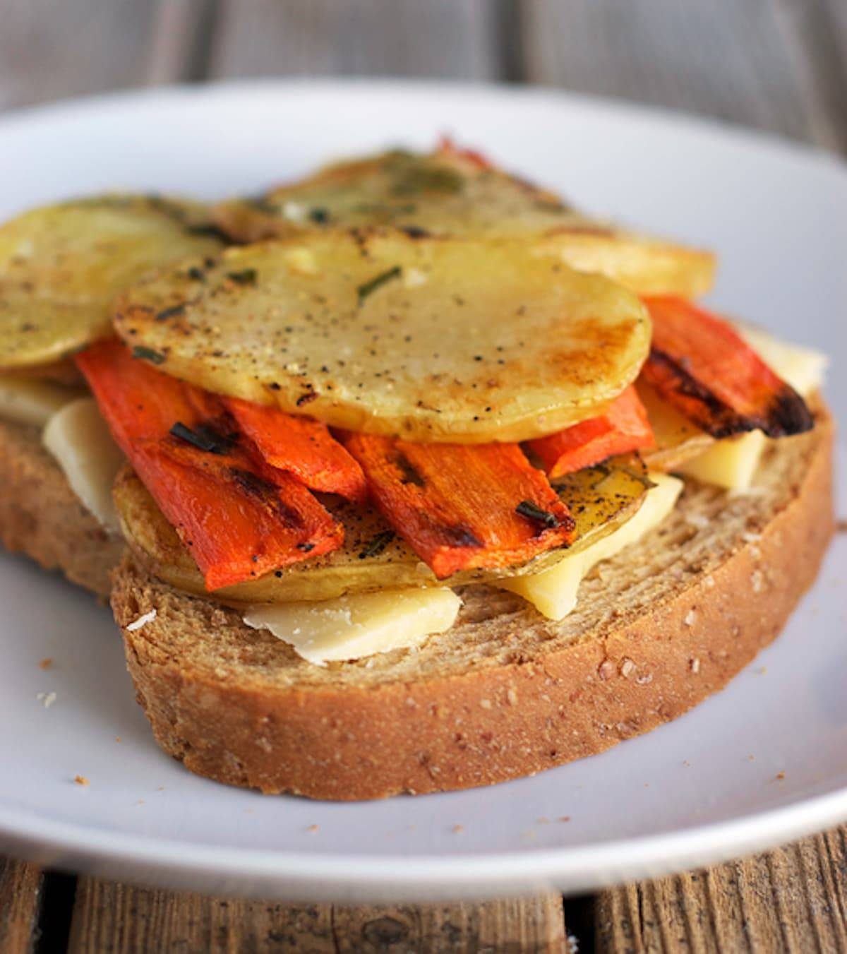 Three cheese grilled cheese open with veggies.